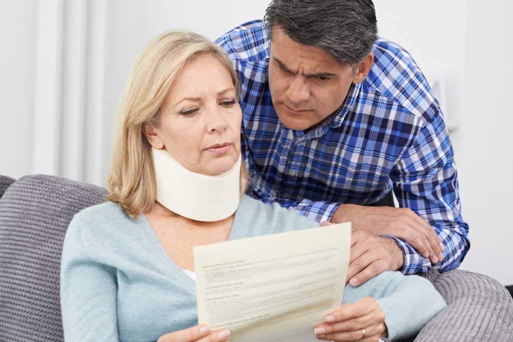 Injured woman and her husband reading a document