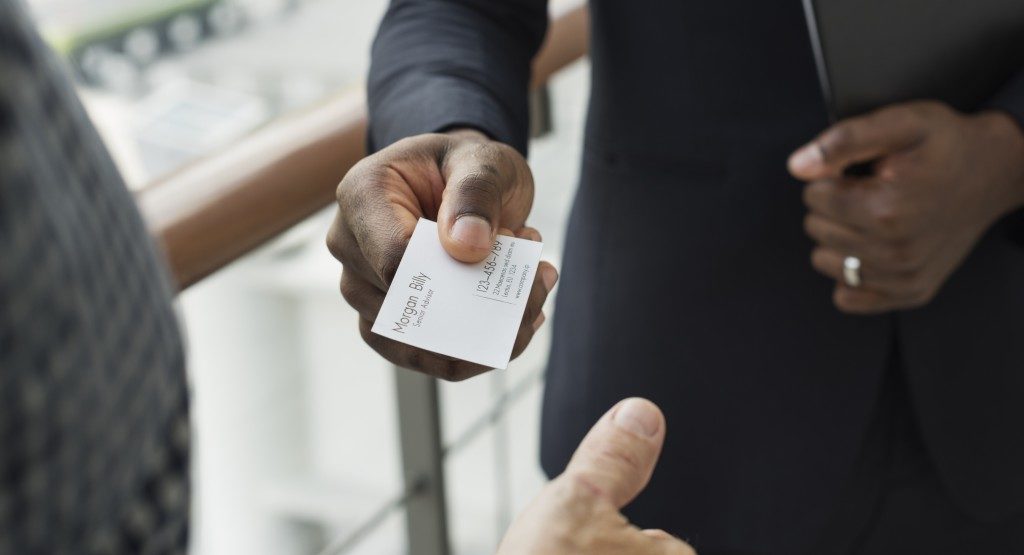 Man handing over his business card