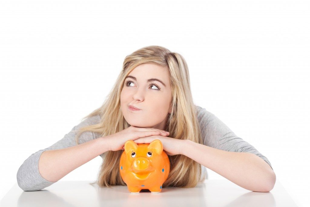 Female with orange piggy bank