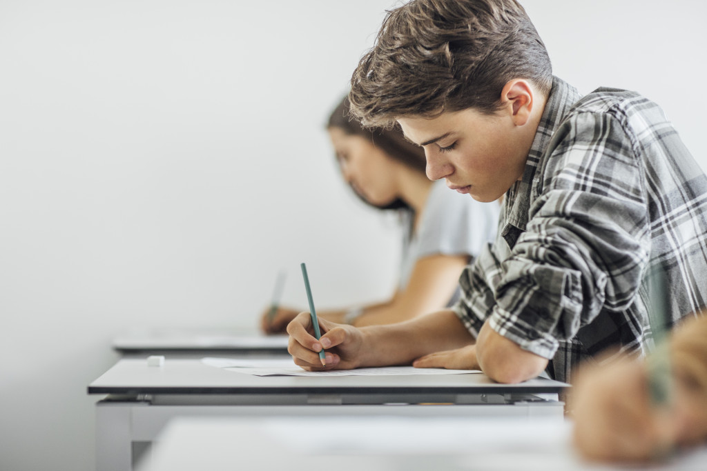 high school student taking an exam