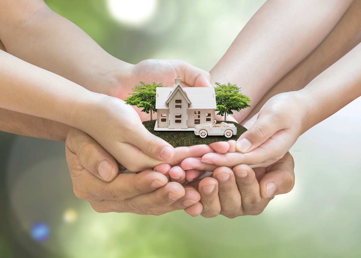 hands holding a home model