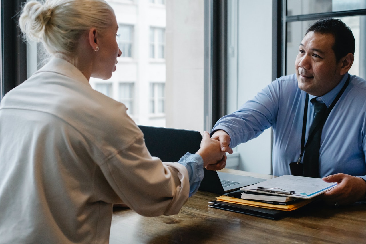 employee and employer shaking hands