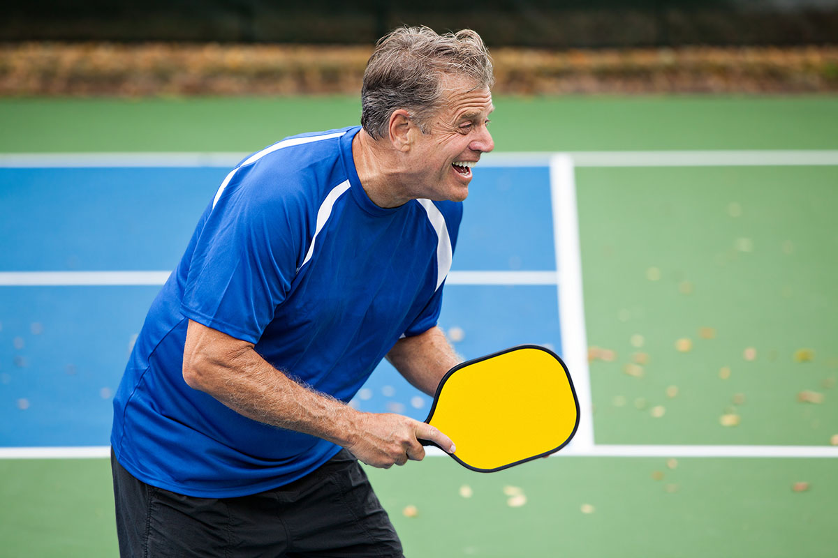 old man playing tennis