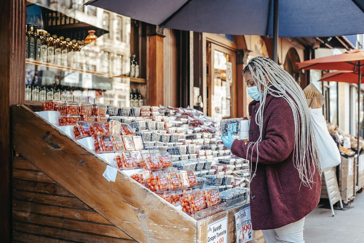 woman wearing a mask buying from a store