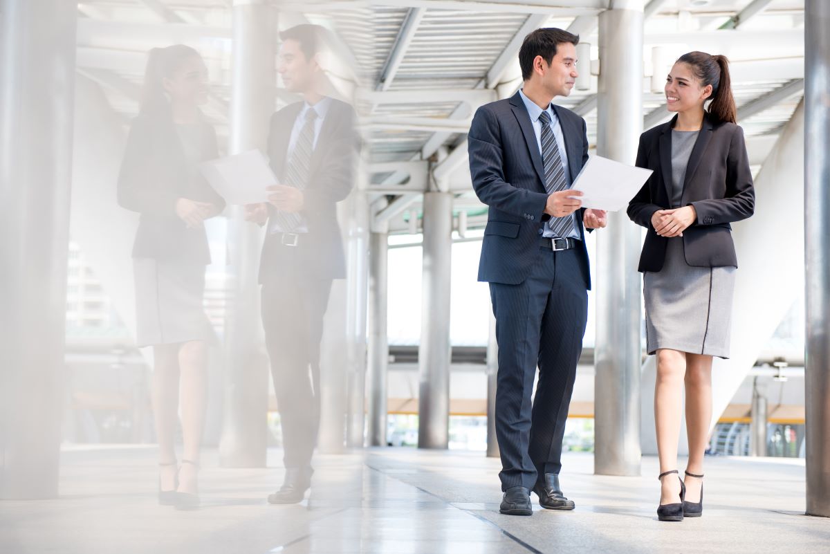 businessman speaking to female colleague 