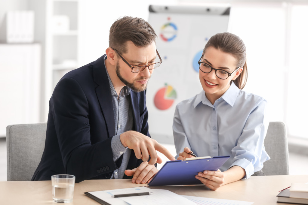 man consulting woman about work