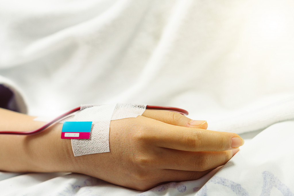 hand with a catheter tube for blood