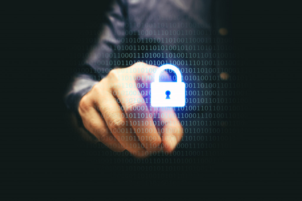 A businessman touching a padlock icon