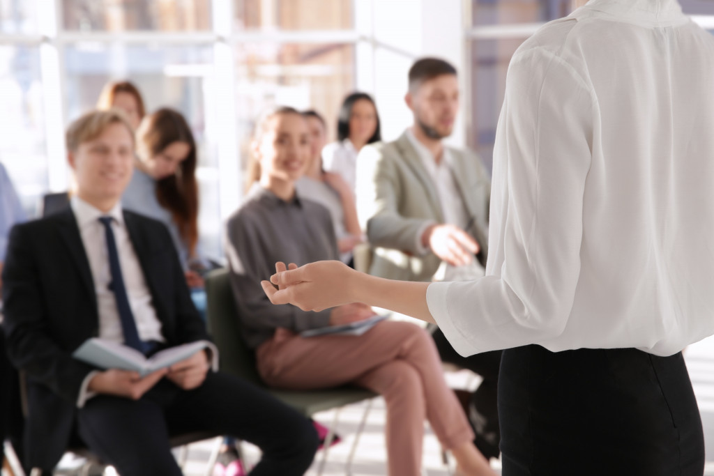 Manager discussing company policies with employees at a conference room.