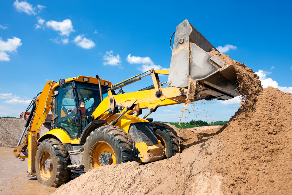 Payloader used on a pile of sand at a construction site.