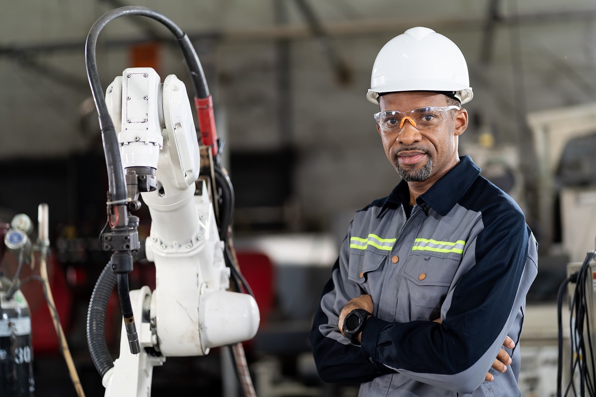 male technician worker with automatic robotic hand machine