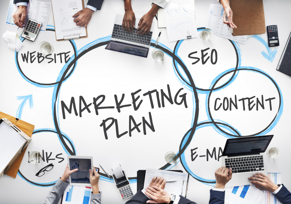 people in a table discussing with circles filled with marketing strategies on the table