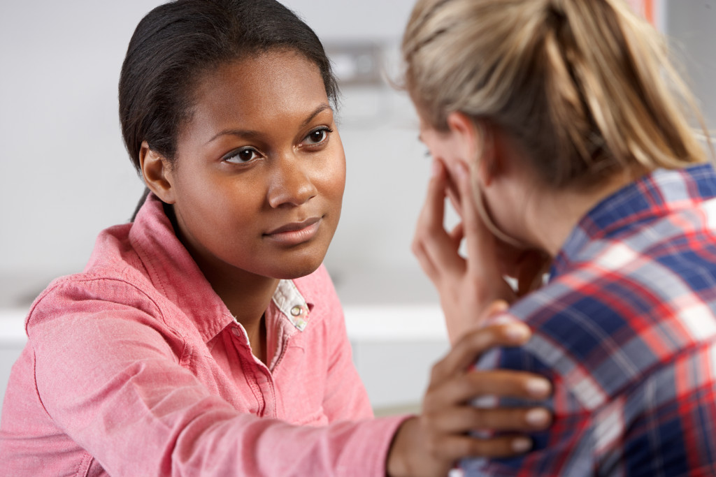 A psychiatrist talking to a teenager